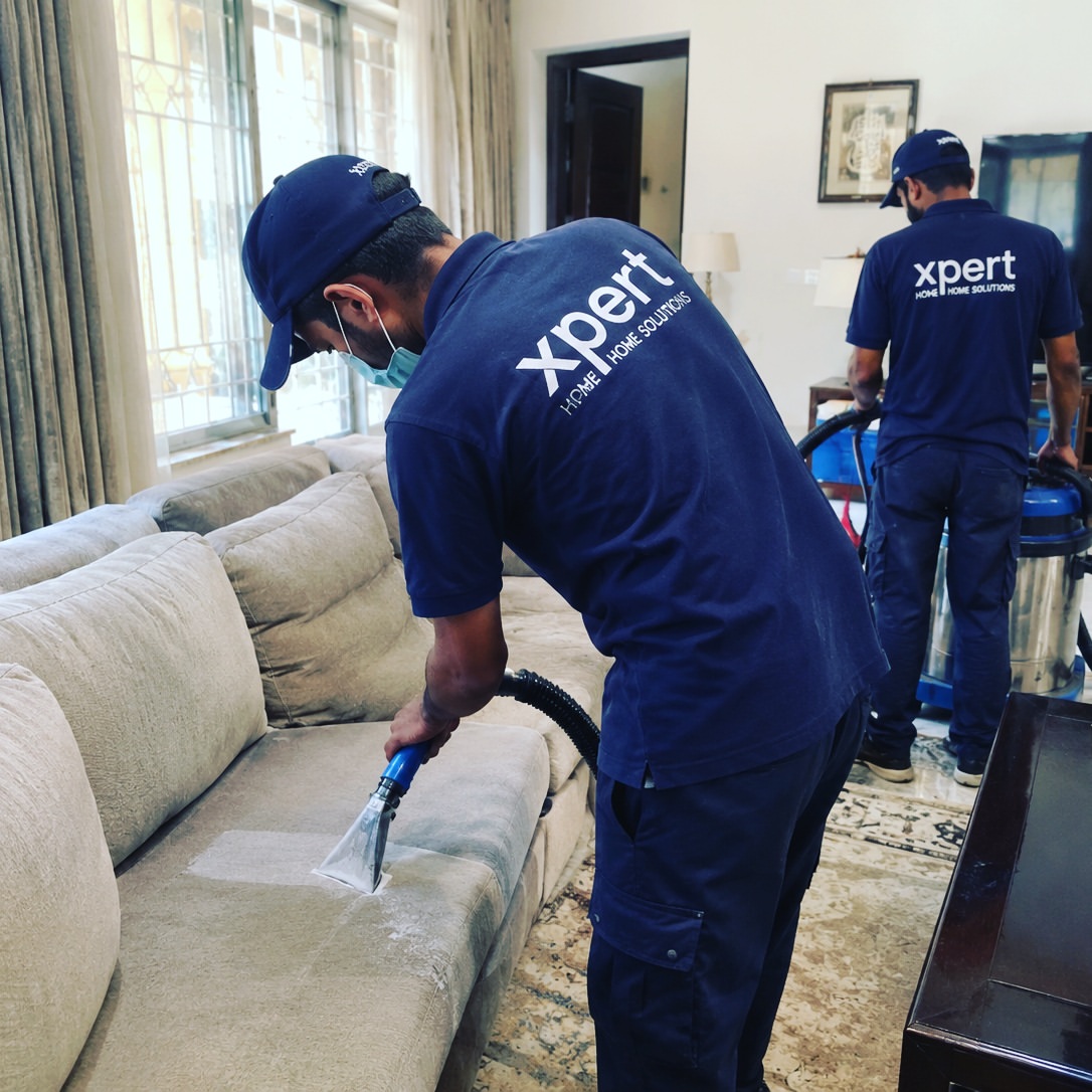 Xpert Home Solutions team cleaning sofa